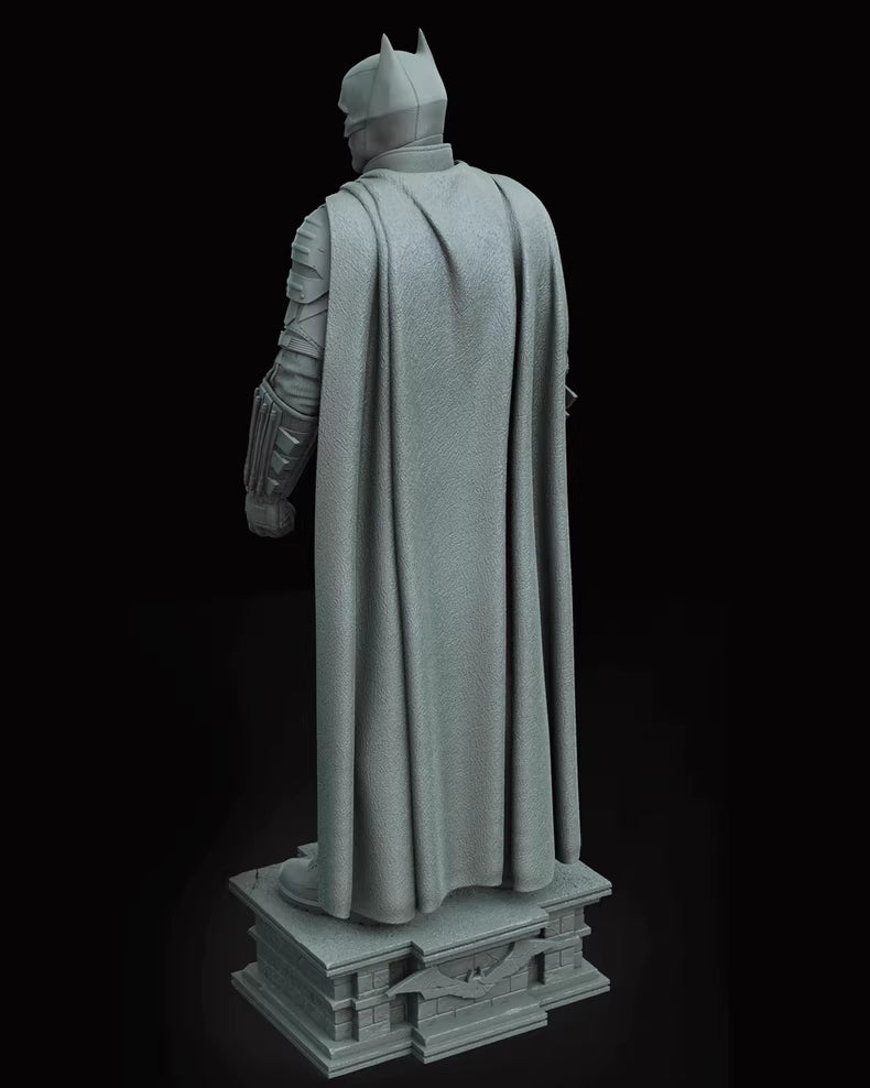 Statue of a character in a cape on a dark background