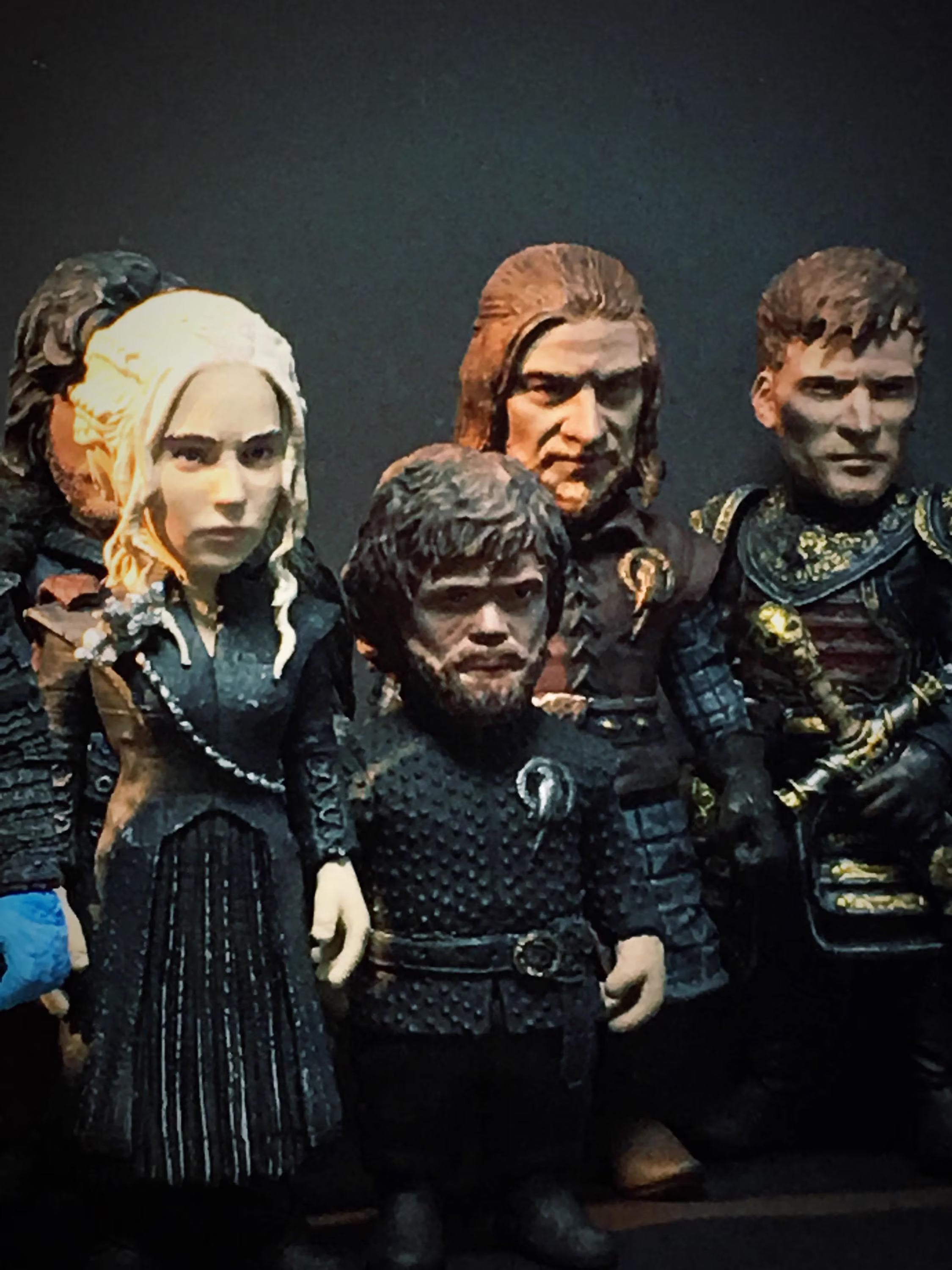 Figures of characters from a fantasy series on a dark background