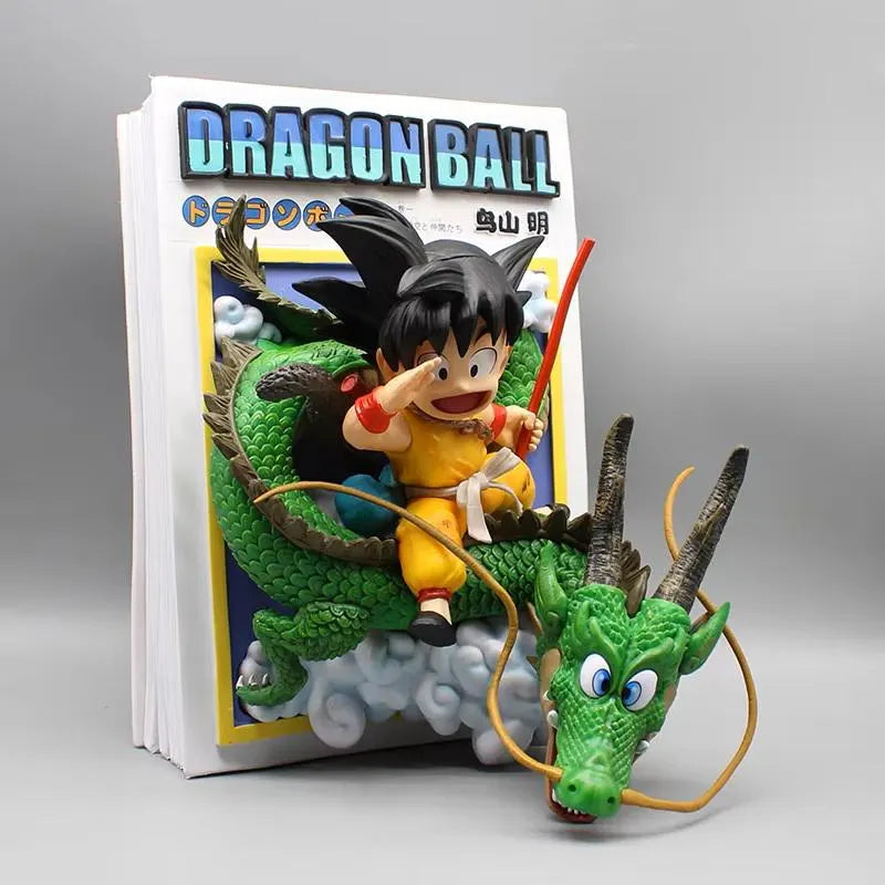 Dragon Ball-themed figurine of a character riding a dragon in front of a Dragon Ball book
