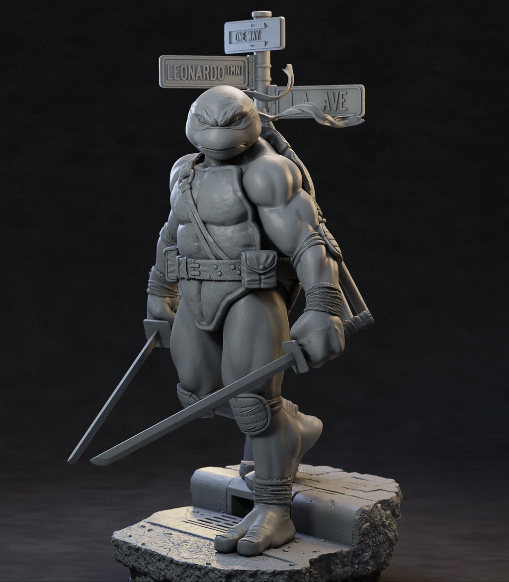 A gray 3D-printed或未上漆 figurine of a Teenage Mutant Ninja Turtle standing on a stone-like base, holding two swords, with a street-sign prop behind it against a dark studio background.