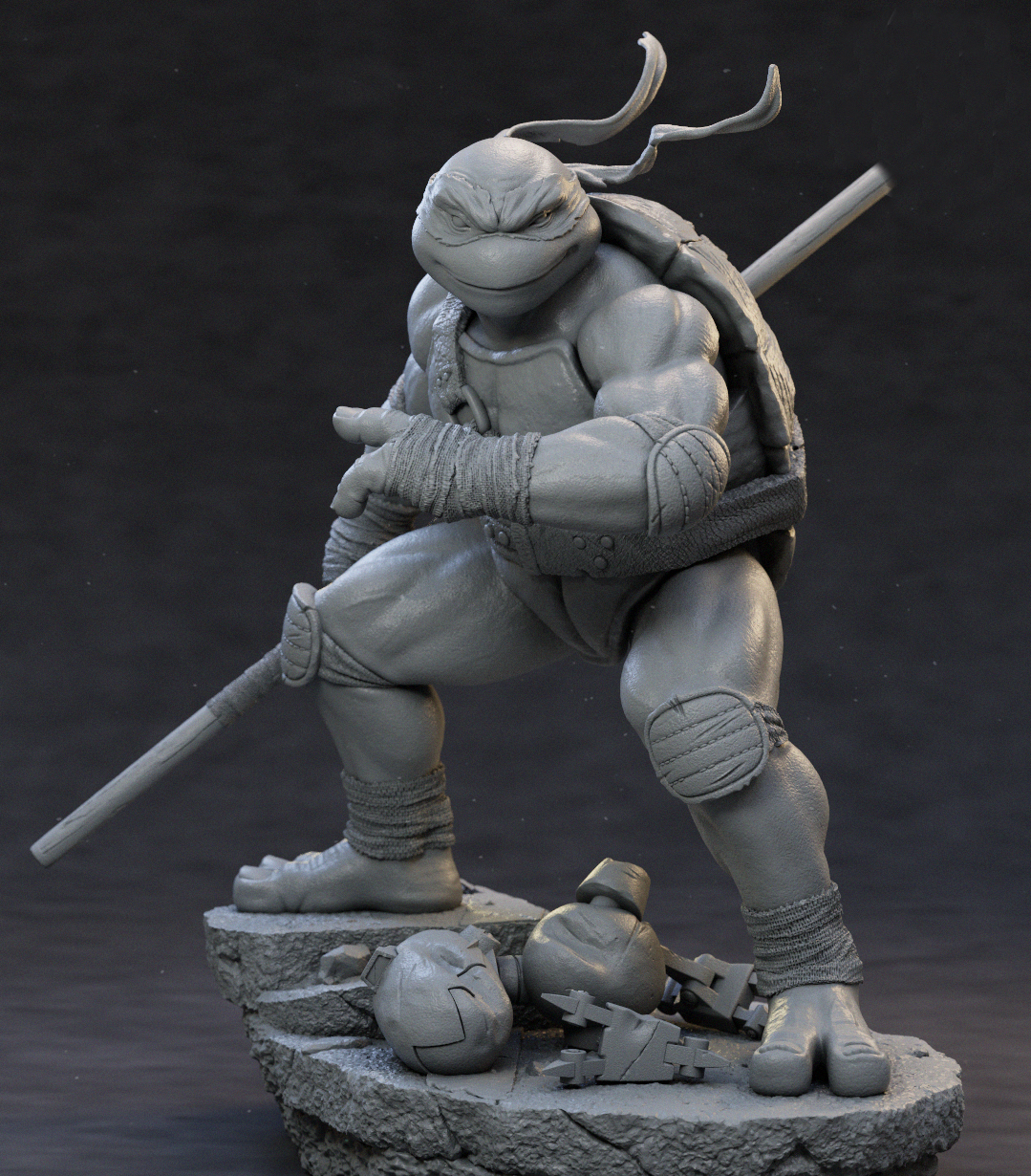 A monochrome gray 3D-printed或未上漆 collectible statue of a Teenage Mutant Ninja Turtle in a crouching pose, holding a sai, standing on a rocky base with two helmets at its feet, photographed against a dark studio background.