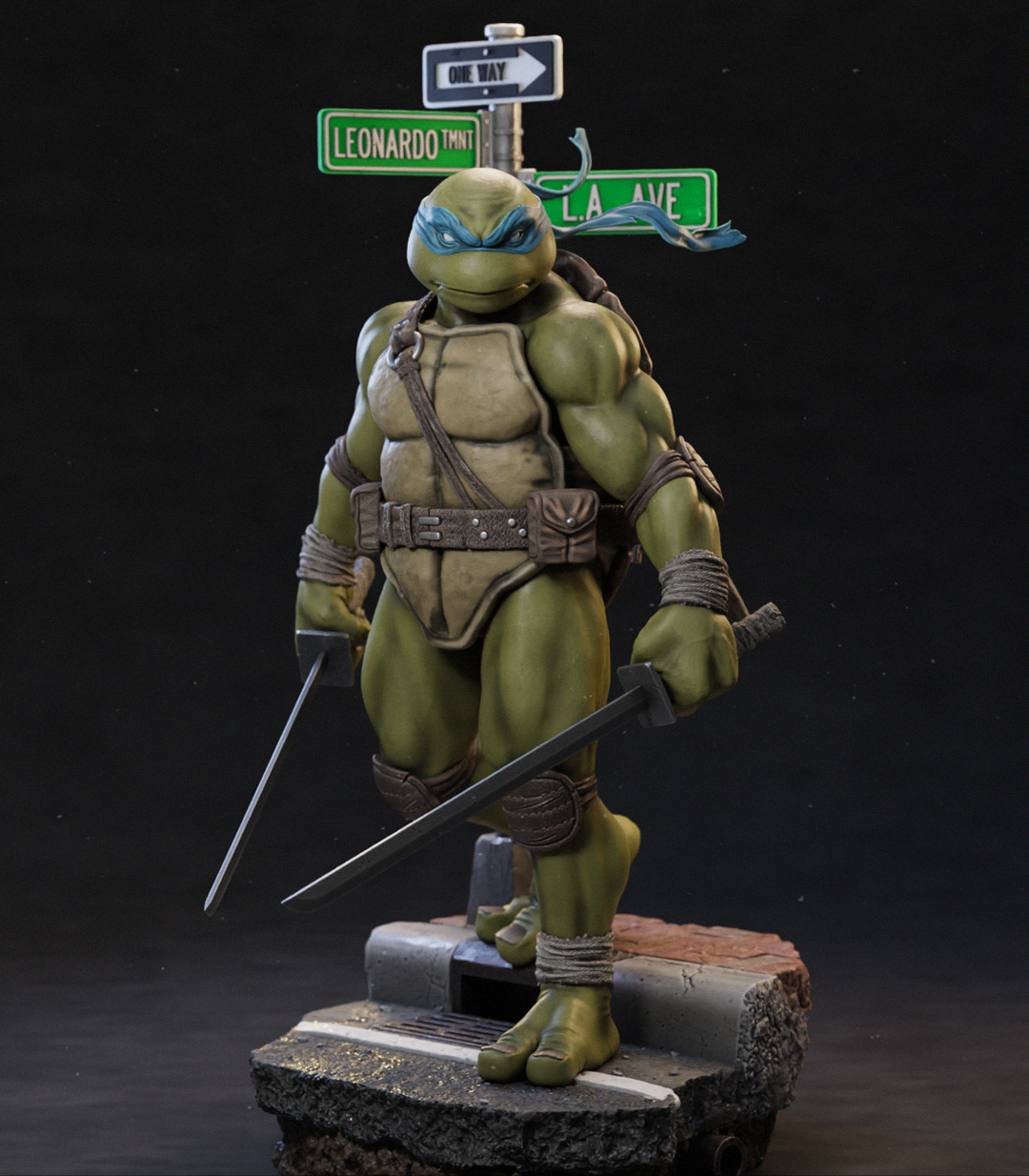 A detailed collectible statue of a Teenage Mutant Ninja Turtle standing on a textured base, holding two swords, with street signs behind it against a dark studio background.