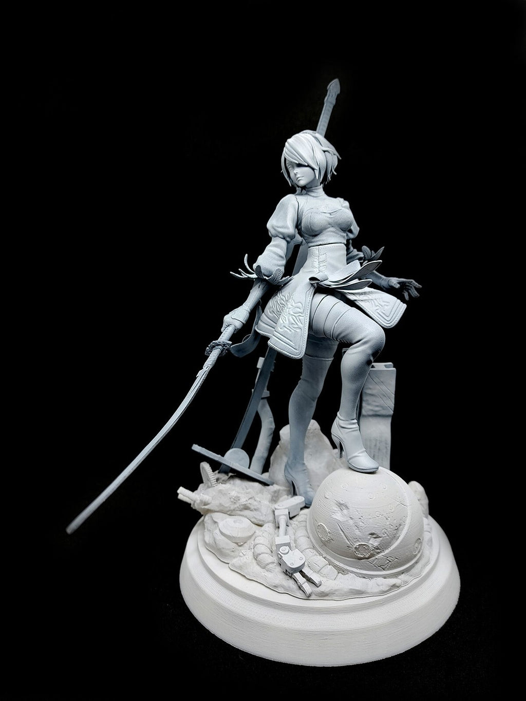 An unpainted white resin figurine of a female warrior character holding a sword, standing on a detailed round base against a solid black background.