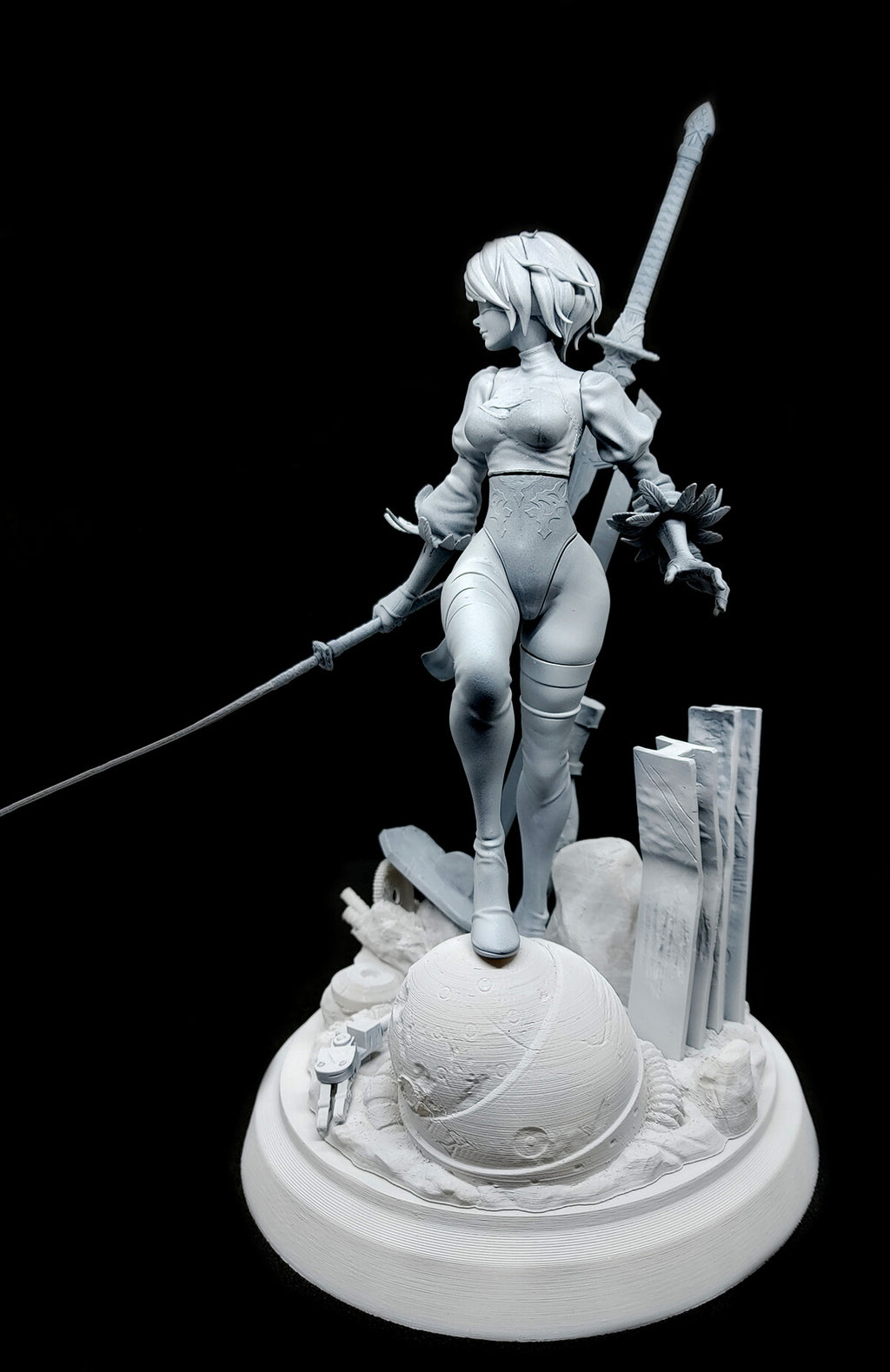 A monochrome unpainted resin statue of a female warrior holding a sword, standing on a detailed round base with a globe and ruins, photographed against a solid black background.