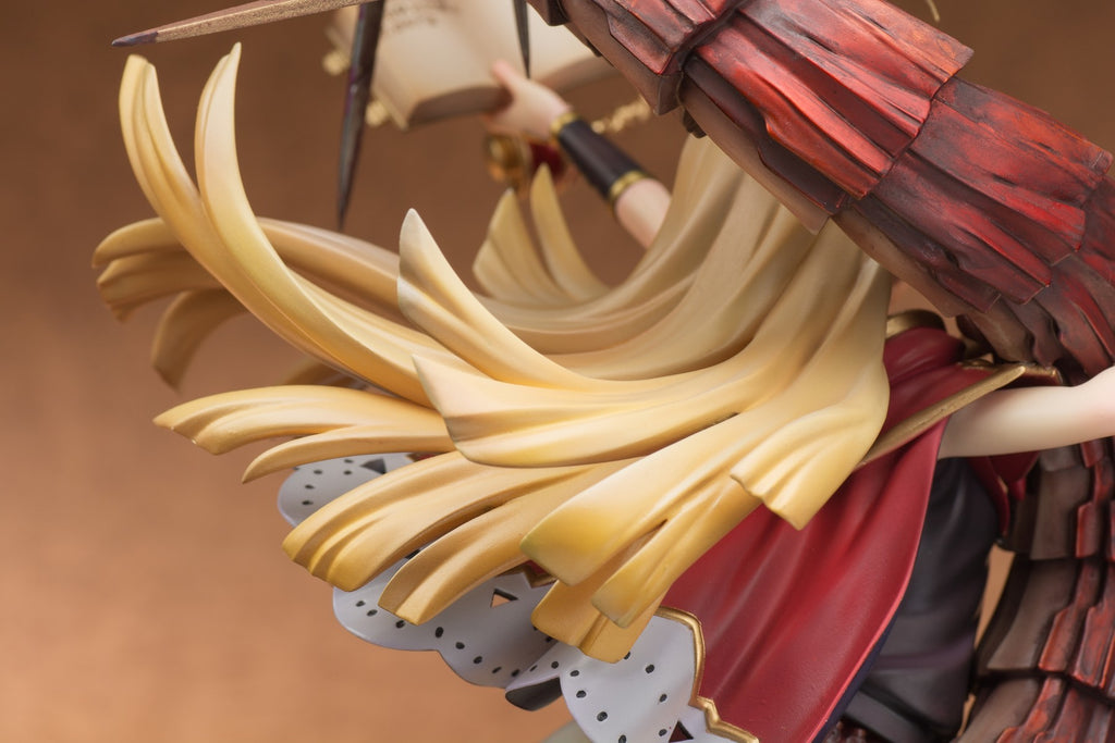 Close-up of a figurine with red and gold details on a blurred background