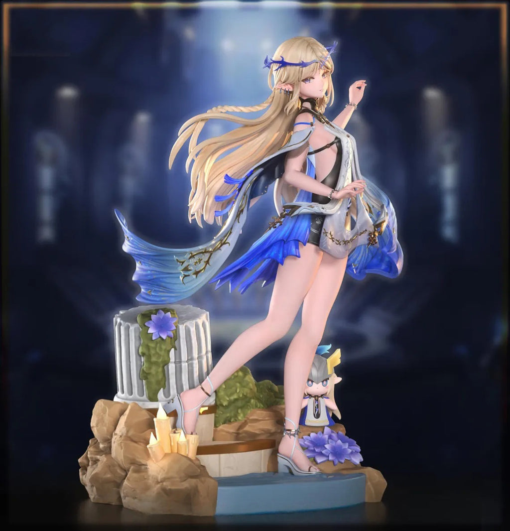 Mermaid figurine with blue tail and flowing hair on a dark background