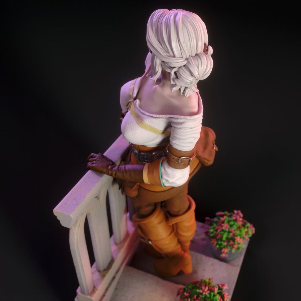 Figurine of a character with white hair and orange outfit standing on a ledge with a dark background