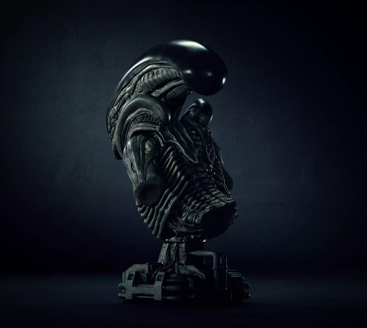 A dark, highly detailed sci-fi creature bust sculpture on a pedestal, photographed in dramatic low-key lighting against a dark studio background.
