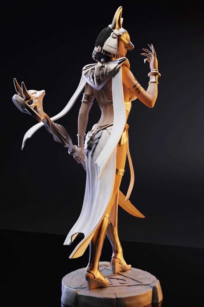 Statue of a winged Egyptian deity on a dark background