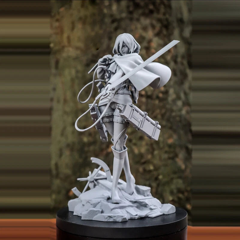 Unfinished sculpture of a character holding a weapon on a black base against a blurred natural background