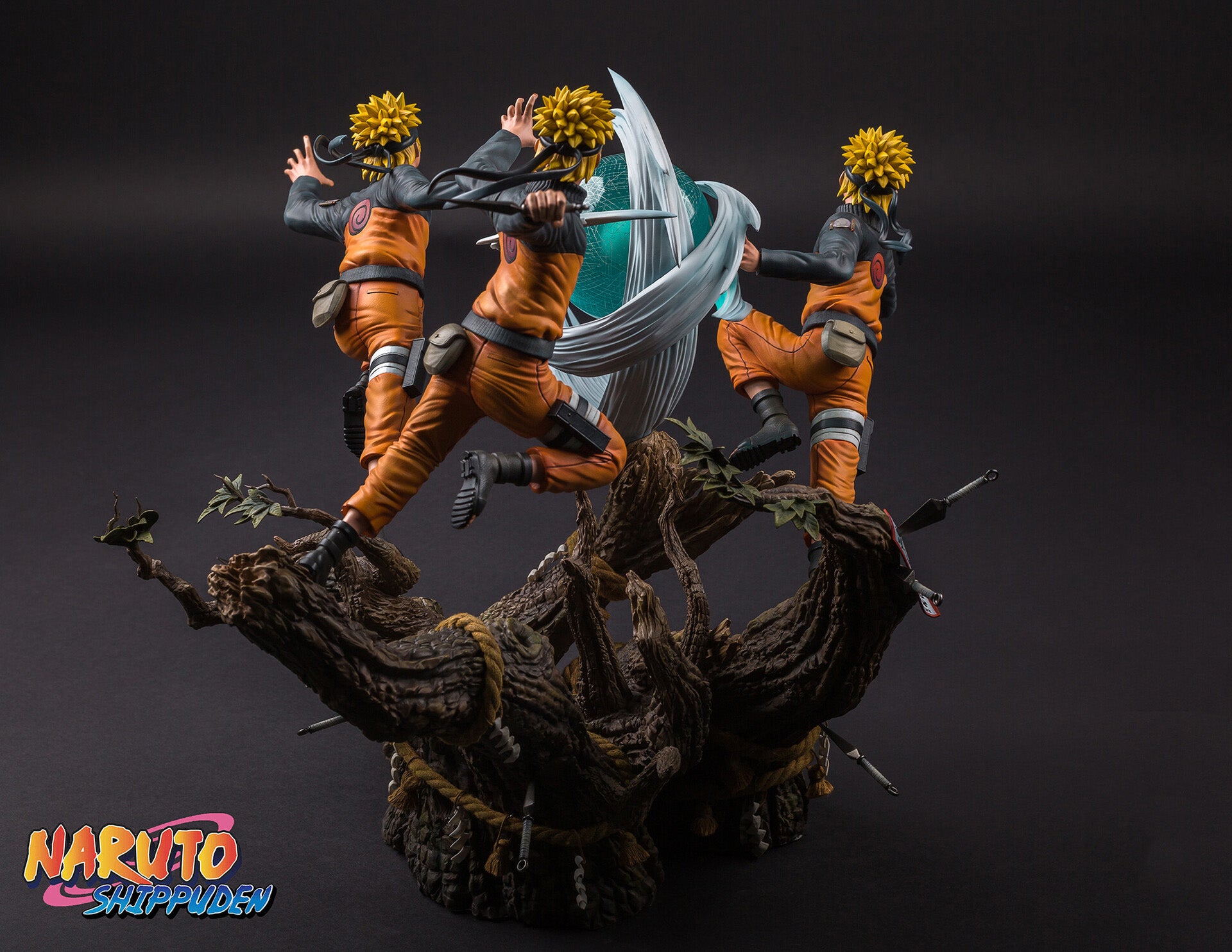 Statue of a character from 'Naruto' with multiple poses on a dark background