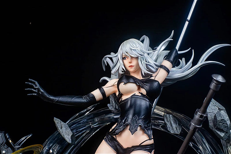 Statue of a character with white hair and black outfit against a dark background