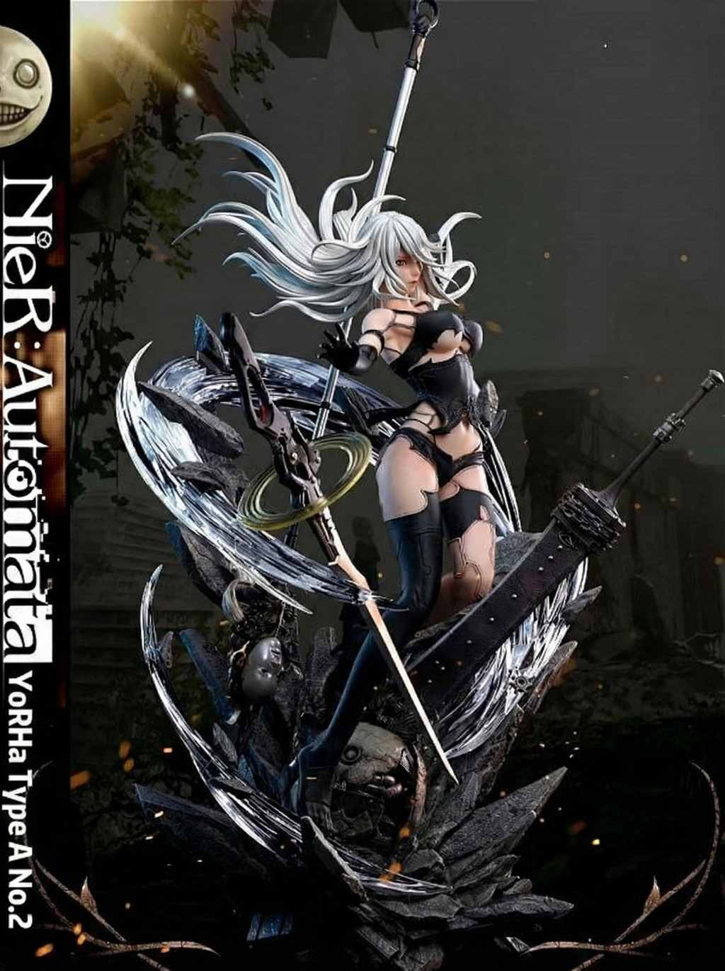 Figurine of a character from NieR: Automata with long white hair and black outfit, holding a weapon.