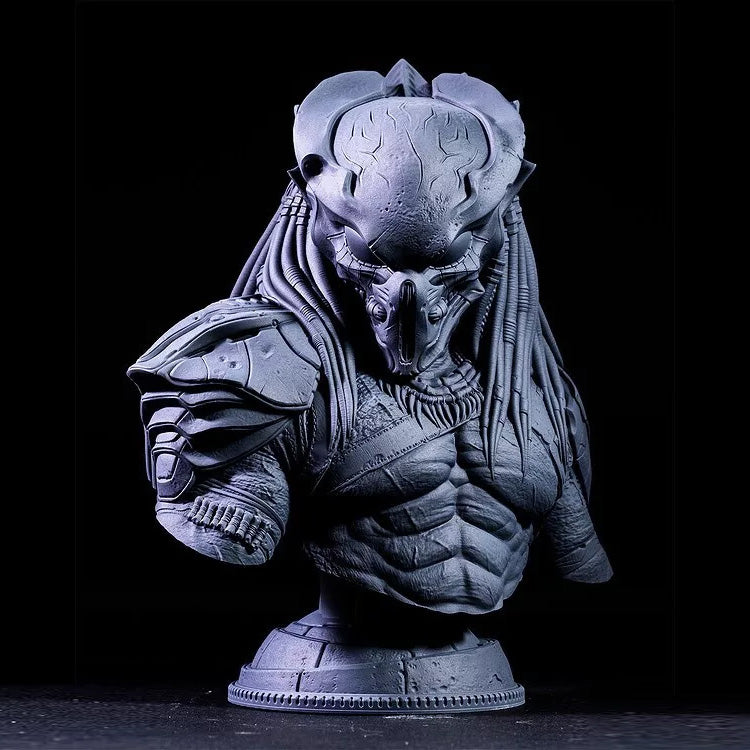 Gray alien predator bust sculpture on a black background