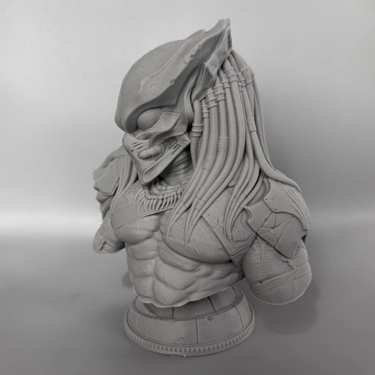 Gray scale bust of a predator warrior with long hair on a gray background