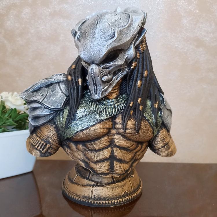 Predator figurine on a reflective surface with a neutral background