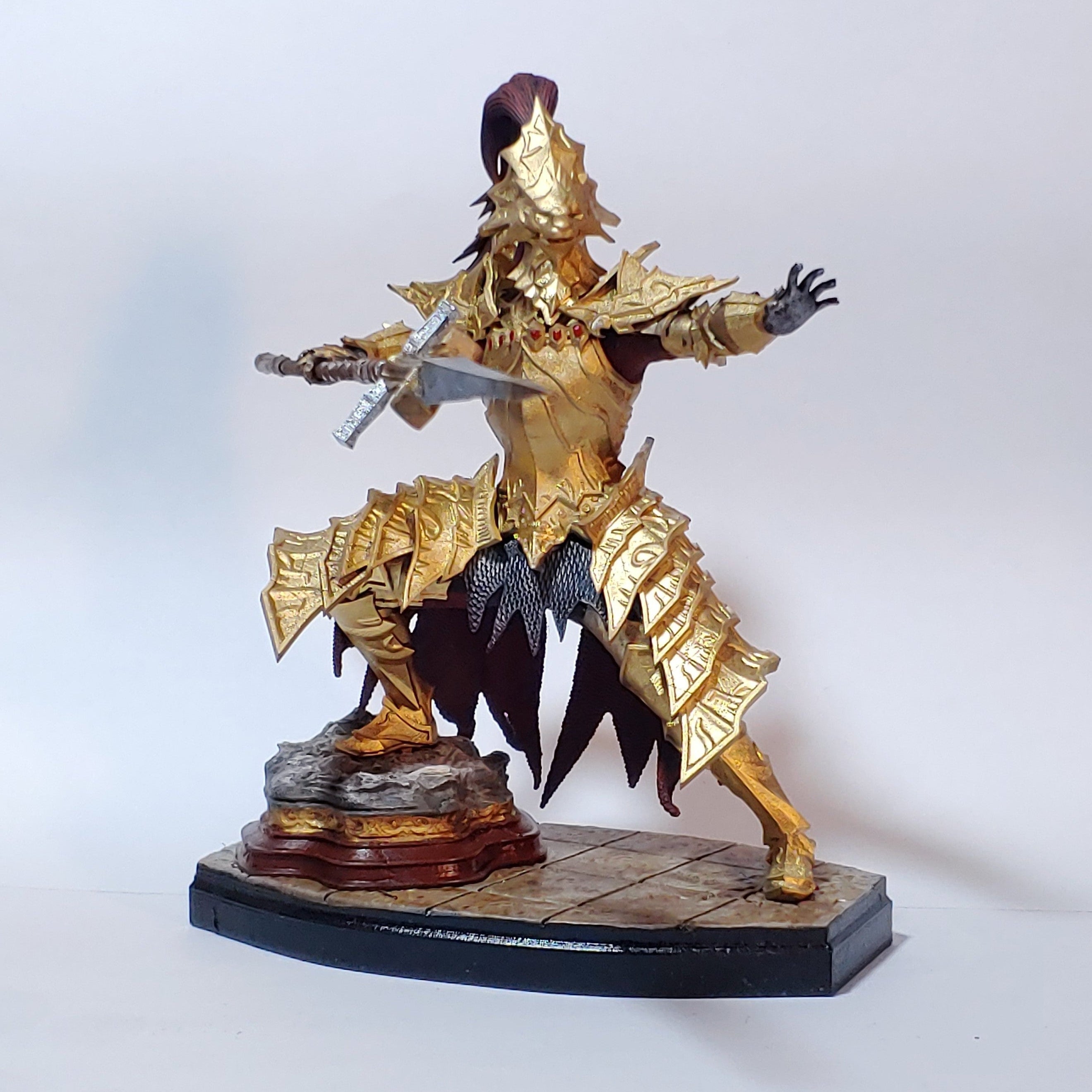 Gold and black warrior figurine on a white background