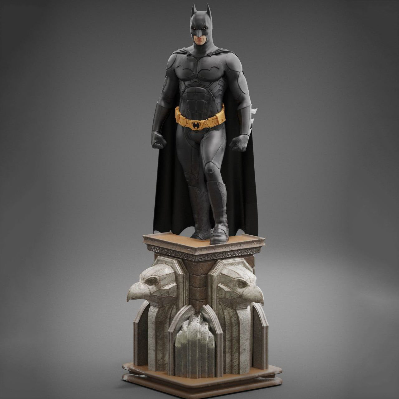 Batman statue on a decorative pedestal against a gray background