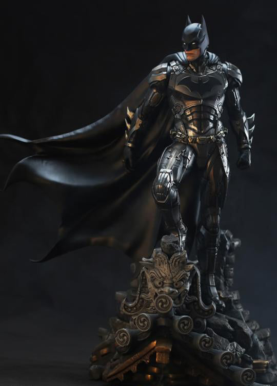 A highly detailed Batman armored figure statue standing on an ornate dark base against a black studio background.
