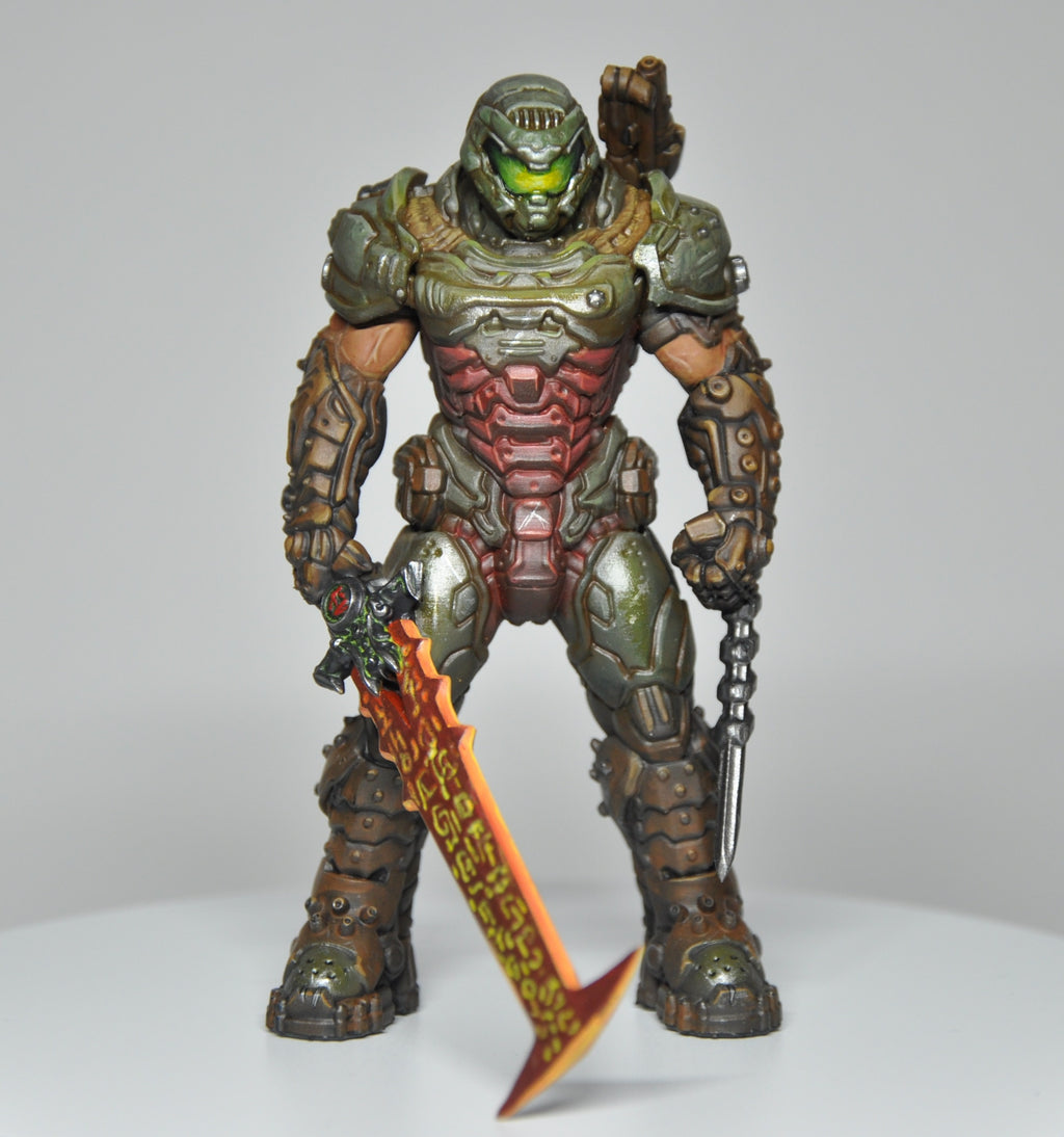 Action figure with detailed armor and weapons on a plain background