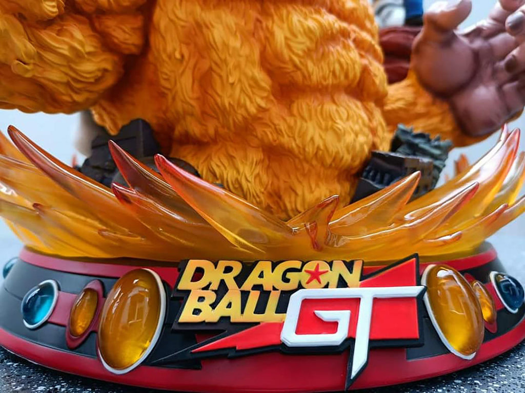 Close-up of a Dragon Ball GT logo on a character's headpiece with flames.