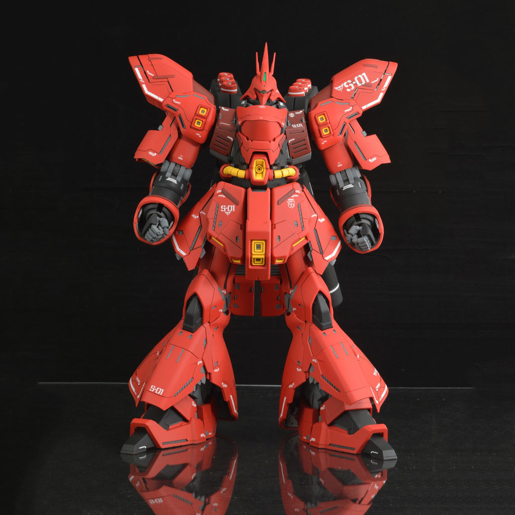 Red robot model on a reflective surface with a black background