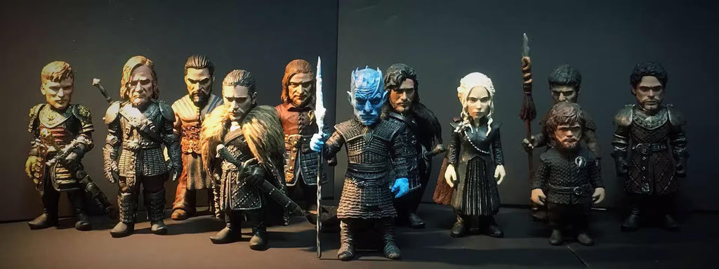 Collection of action figures in various poses against a dark background