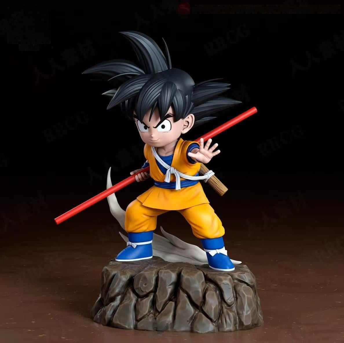 Figurine of a character in orange and blue outfit with a red staff on a dark background