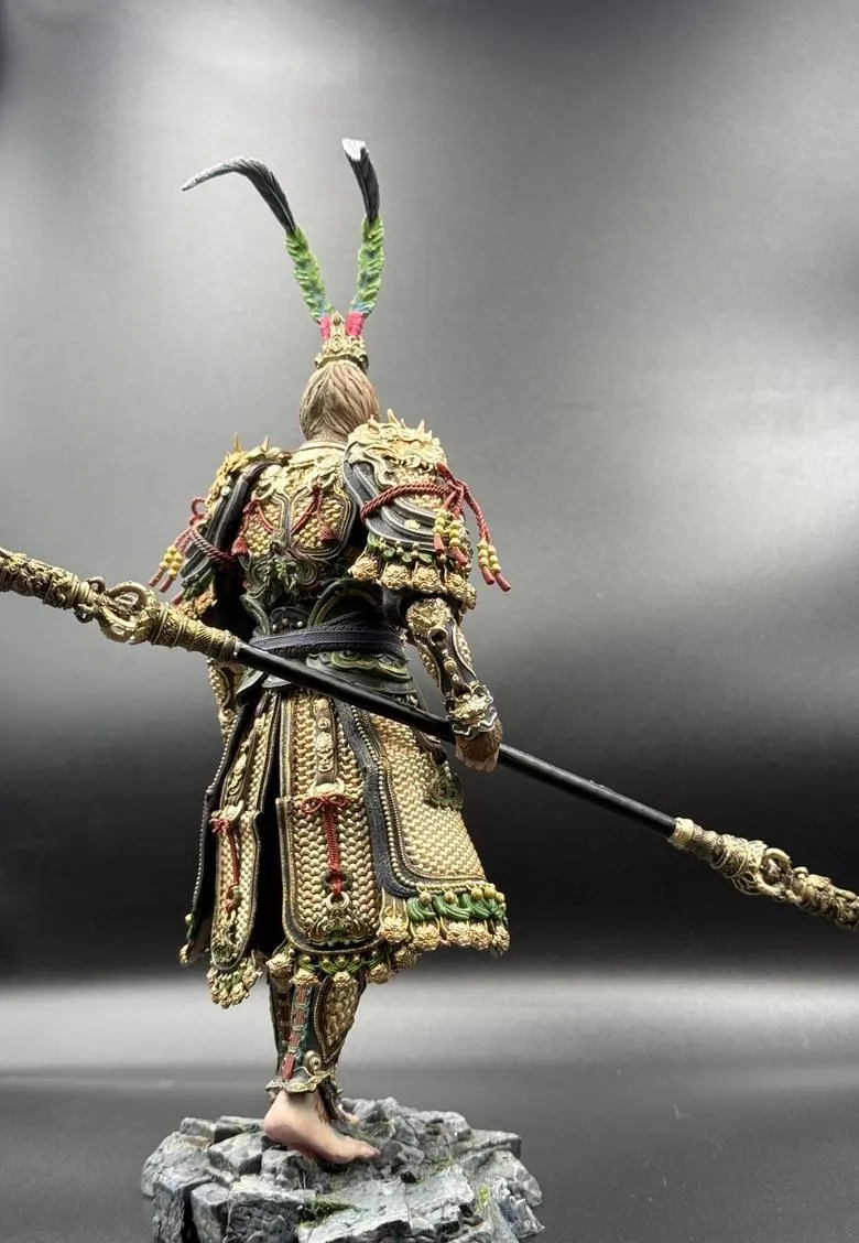 Detailed figurine of a warrior in ornate armor with a spear on a gray background