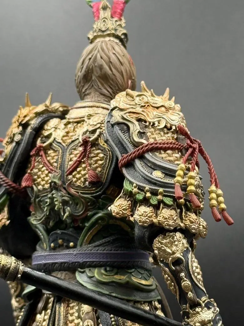 Close-up of a detailed armor with gold and black colors on a gray background