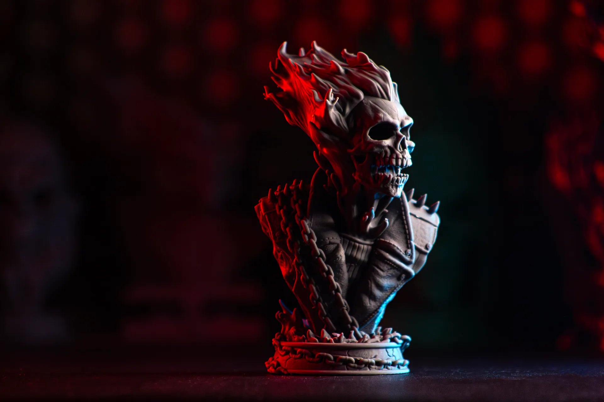 Skull-shaped bust with glowing blue and red lights on a dark background