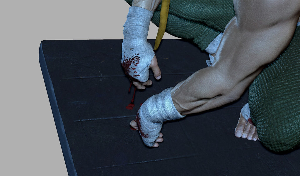 Person with bandaged hands on a dark mat, one hand bloody