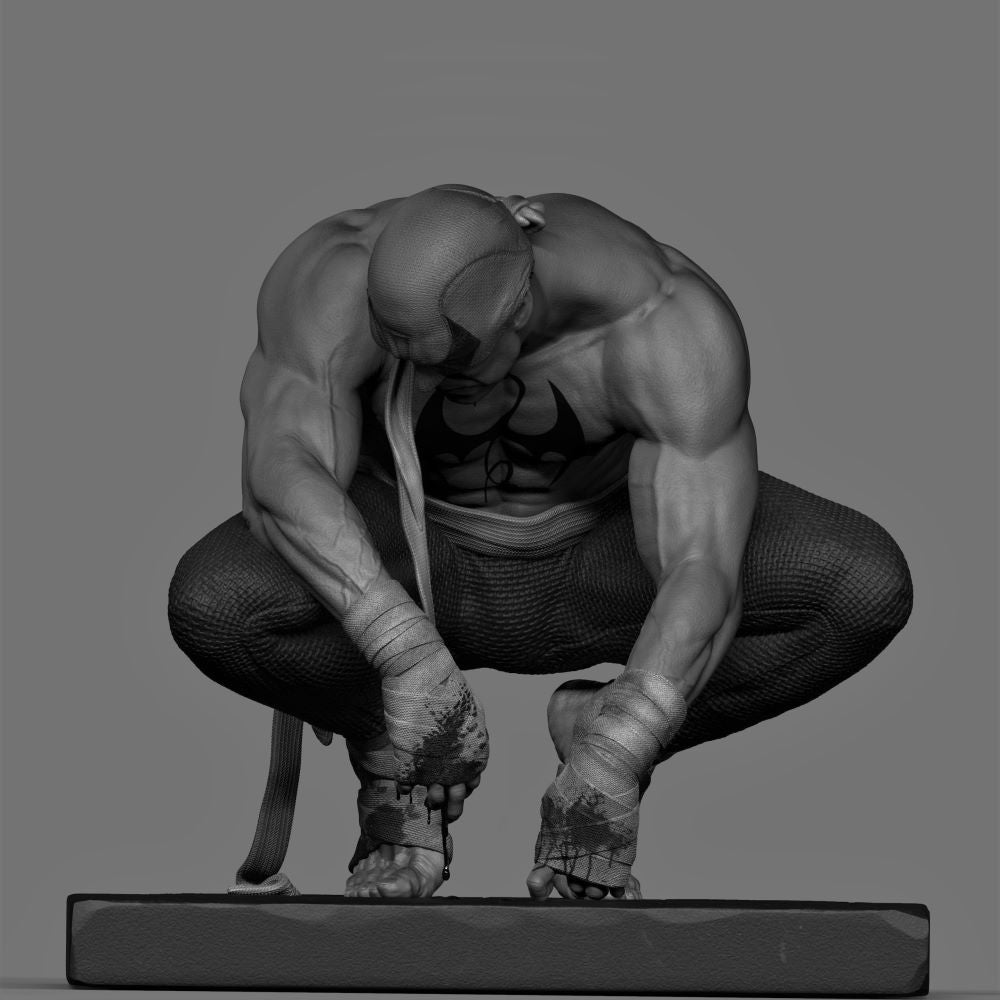 Gray-scale sculpture of a muscular figure in a crouching pose on a gray background