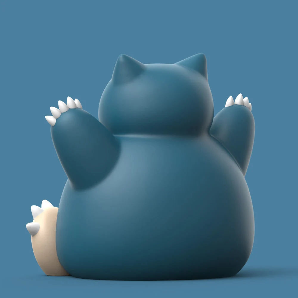 Blue cat-shaped figurine with white paws on a blue background