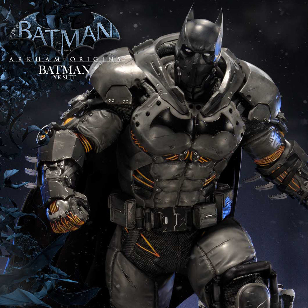 Batman Armored Mecha figure in detailed black and gray armor with orange accents, posed dynamically against a dark blue and black background with Batman logo text in the upper left.