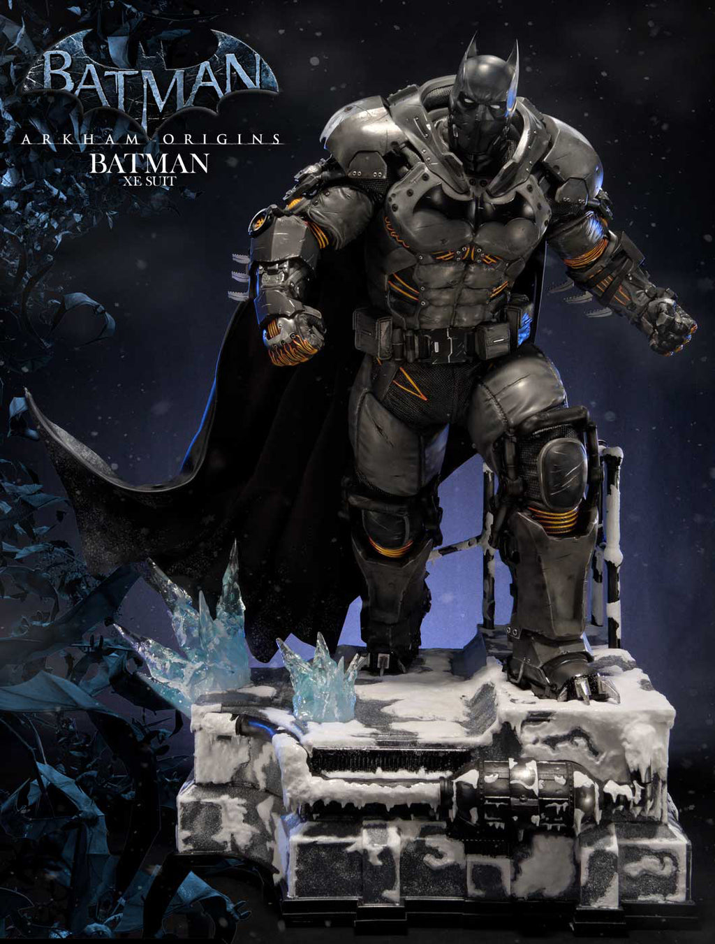 Batman Arkham Origins statue in detailed armored suit, standing on a snowy, battle-damaged base with a dark cape, in a dark icy scene with Batman logo text in the upper left.