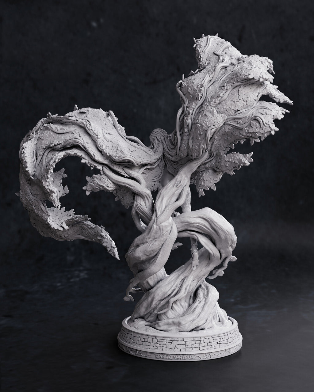 A detailed gray resin or plastic fantasy tree sculpture with twisted roots and textured foliage, displayed on a circular base against a dark studio background.