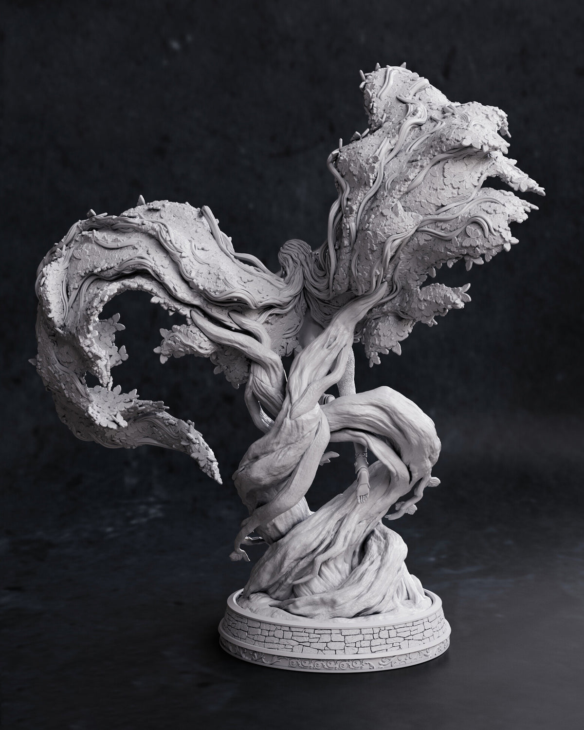 A detailed gray resin or plastic fantasy tree sculpture with twisted roots and textured foliage, displayed on a circular base against a dark studio background.