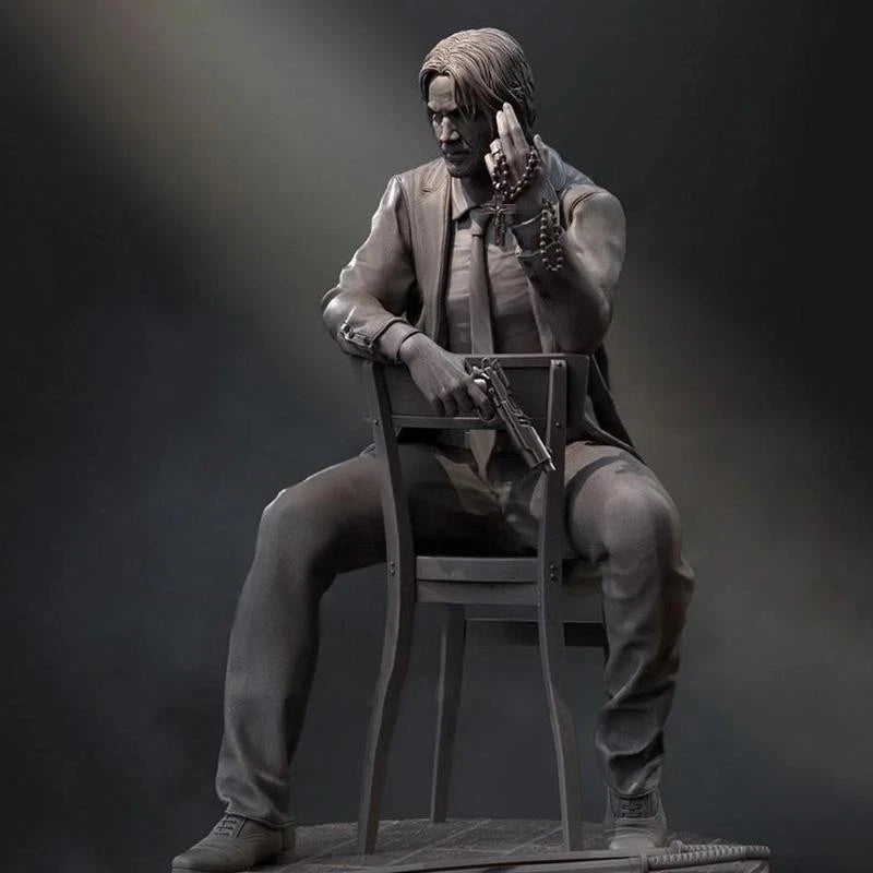 Statue of a person sitting on a chair with a gun, wearing a coat and pants, against a dark background.