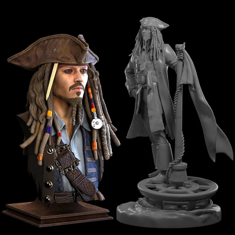 Model of a character with a hat and long hair, next to a gray scale model of a different character on a stand.