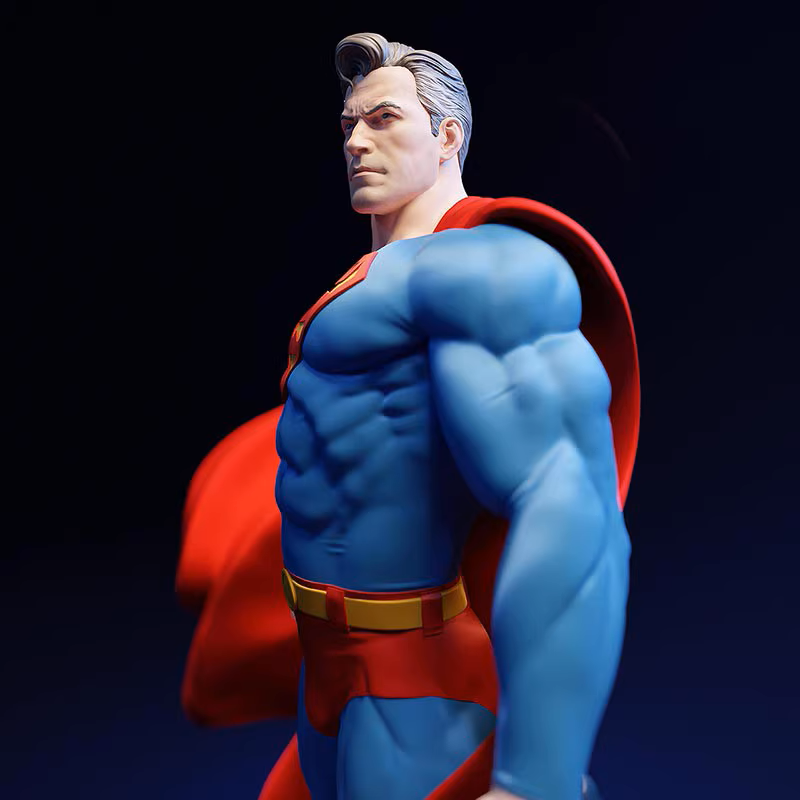 Superman figurine with red cape and blue suit on a dark background