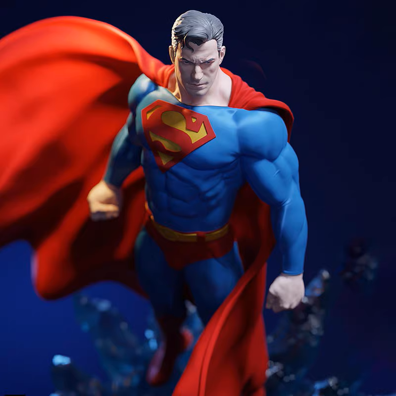 Superman figurine with red cape and blue suit against a dark background
