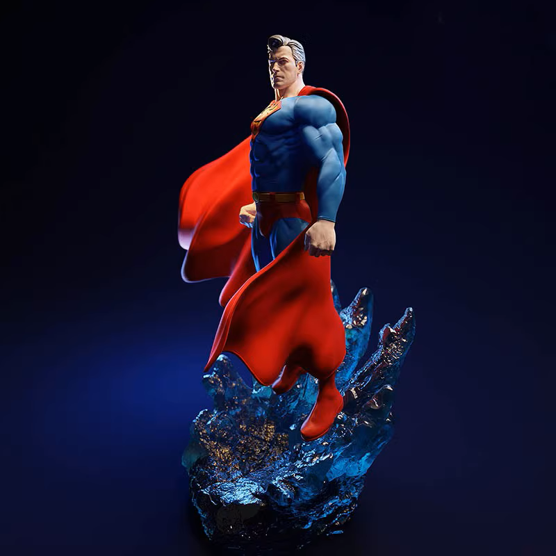 Superman figurine with red cape and blue suit on a dark background