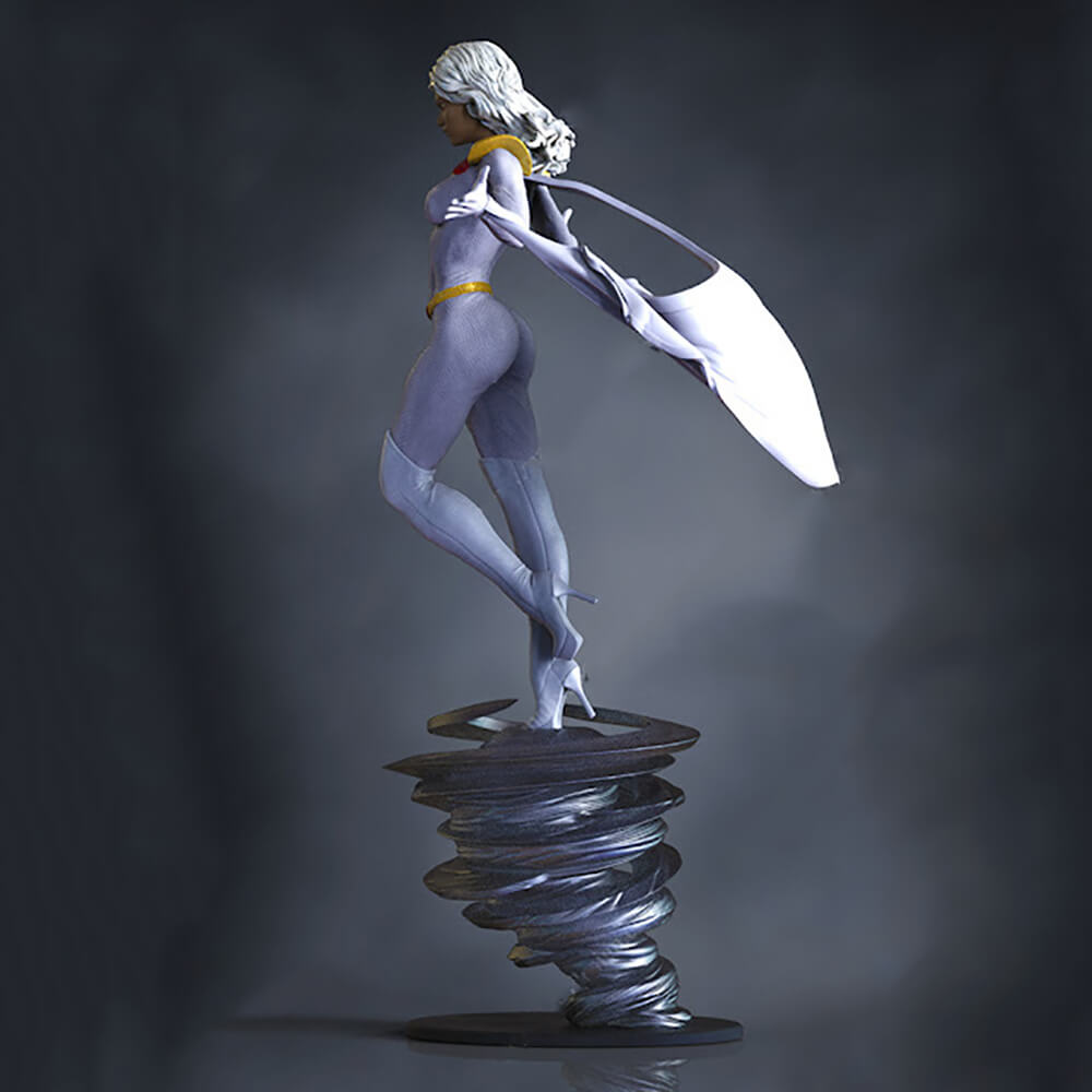 A stylized collectible figurine of a female superhero standing on a swirling metallic base against a dark gray studio background. The figure has silver-gray skin, white hair, a yellow belt, and holds a large white cape or shield.