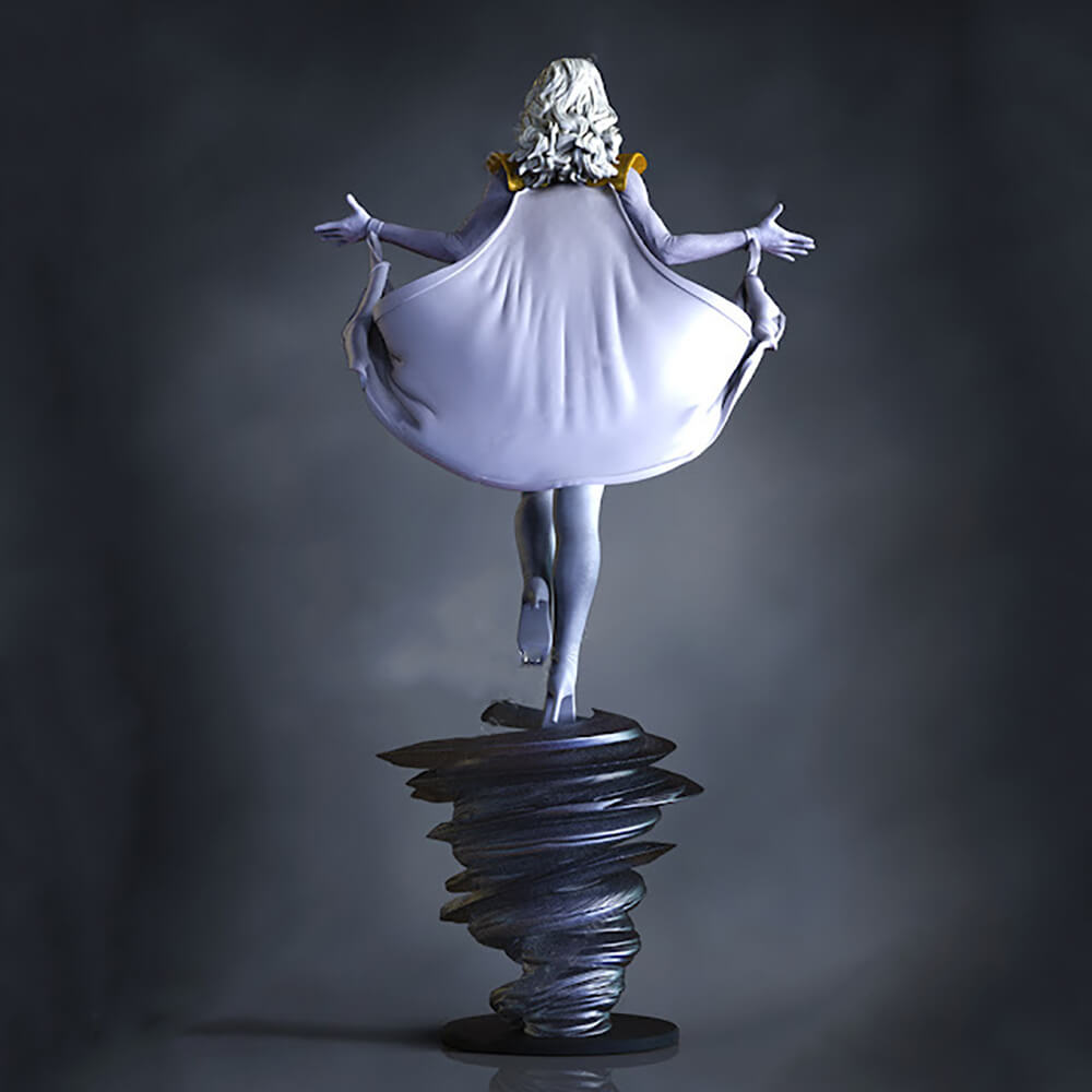 A stylized statue of a woman with long white hair, viewed from behind, wearing a flowing pale lavender dress and holding out her arms. She stands on a dark spiral base against a dark gray studio background.